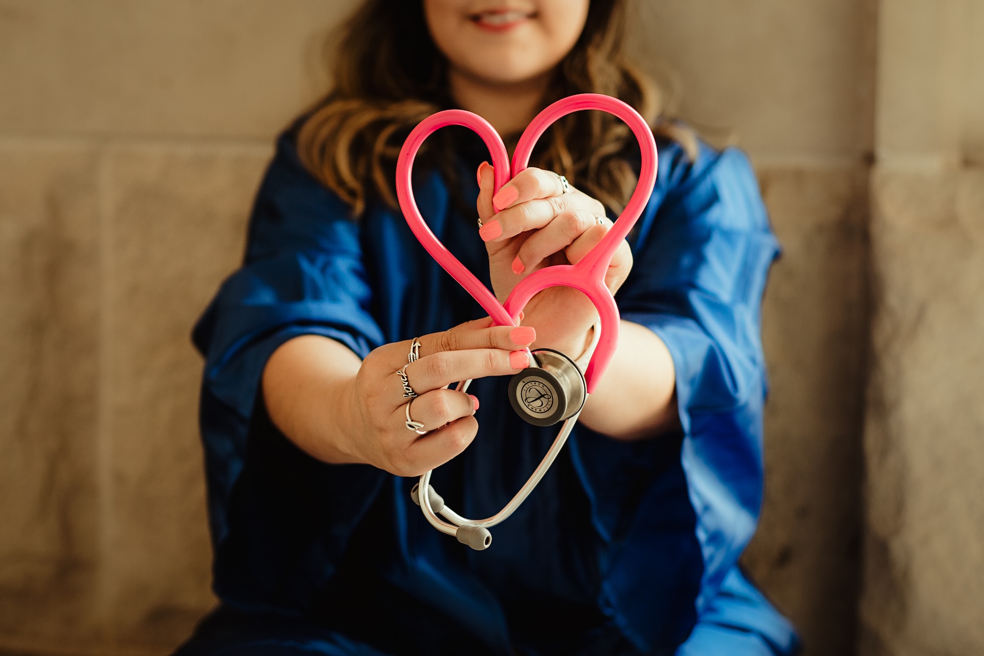 Doctor holding a stethoscope in the shape of a heart
